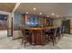 Elegant basement bar with dark wood cabinetry and granite countertop at 4567 Brigade Ne Ct, Roswell, GA 30075