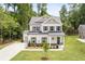 Two story home with driveway and landscaping at 4405 Ryker Rd, Cumming, GA 30041