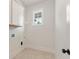 Laundry room with white cabinets, tile floor and window at 4405 Ryker Rd, Cumming, GA 30041