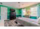 Bright bedroom with teal walls, wood floors, and a comfortable bed at 303 Walnutwood Trl, Roswell, GA 30075