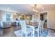 Open concept dining area with hardwood floors and kitchen view at 303 Walnutwood Trl, Roswell, GA 30075