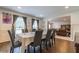 Bright dining room with hardwood floors, seating for eight, and view of Gathering room at 303 Walnutwood Trl, Roswell, GA 30075