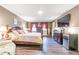 Main bedroom with king-size bed, hardwood floors, and built-in cabinetry at 303 Walnutwood Trl, Roswell, GA 30075