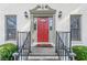 Elegant red front door with detailed trim and black railings at 303 Walnutwood Trl, Roswell, GA 30075
