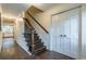 Elegant staircase with dark wood and iron railing at 303 Walnutwood Trl, Roswell, GA 30075