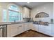 Modern kitchen featuring stainless steel appliances and white cabinetry at 303 Walnutwood Trl, Roswell, GA 30075