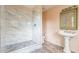 Elegant bathroom with marble shower, pedestal sink, and updated fixtures at 303 Walnutwood Trl, Roswell, GA 30075