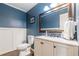 Updated bathroom with granite vanity and dark blue walls at 303 Walnutwood Trl, Roswell, GA 30075