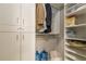 Large walk-in closet with shelving and hanging rods at 303 Walnutwood Trl, Roswell, GA 30075