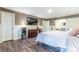 Main bedroom with king-size bed, large TV, and hardwood floors at 303 Walnutwood Trl, Roswell, GA 30075