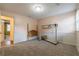 Versatile bedroom with light pink walls, carpeted floors, and access to another room at 303 Walnutwood Trl, Roswell, GA 30075