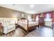 Main bedroom with king-size bed, hardwood floors, and neutral decor at 303 Walnutwood Trl, Roswell, GA 30075