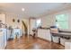 Functional laundry room with cabinets, folding space, and hardwood floors at 303 Walnutwood Trl, Roswell, GA 30075