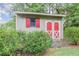 Large storage shed with red doors and shutters at 303 Walnutwood Trl, Roswell, GA 30075