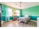 Bedroom with teal walls, gray metal bed frame, and wood flooring at 303 Walnutwood Trl, Roswell, GA 30075