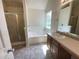 Main bathroom boasts a relaxing jetted tub and shower at 50 Ivans Cir, Covington, GA 30016