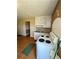 Small kitchen features white cabinets, tiled countertops, and electric range at 3060 Habersham Cir, Covington, GA 30014