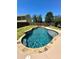 Relaxing kidney shaped pool with stone coping and surrounding lawn at 3060 Habersham Cir, Covington, GA 30014
