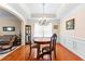 Bright dining room featuring hardwood floors, chandelier, and wainscoting at 3037 Nicholas Dr, Villa Rica, GA 30180