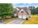 Two-story house with a large front yard and two-car garage at 3037 Nicholas Dr, Villa Rica, GA 30180