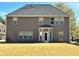 Back of house with a large yard and patio at 3037 Nicholas Dr, Villa Rica, GA 30180