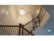 View of a grand staircase with a crystal chandelier and ornate wood railing at 10785 Arlington Pt, Alpharetta, GA 30022