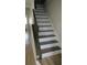 Modern staircase with dark gray railing and white risers at 919 Regency Path Dr, Decatur, GA 30030