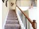 Elegant staircase with wood railing and carpeted steps at 5179 Meadowbrooke Chase, Stone Mountain, GA 30088