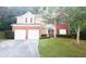 Two-story brick home with a double garage and neat lawn at 5179 Meadowbrooke Chase, Stone Mountain, GA 30088