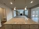 Kitchen island with granite countertops overlooking Gathering room at 255 Arwen Dr, Mcdonough, GA 30252