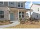 Two-story home with light brick and gray siding, a covered porch, and landscaping at 6280 Misty Hill Ln, Buford, GA 30518