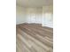 Bright bedroom with wood-look flooring and three closets at 270 Crosstree Ln, Atlanta, GA 30328
