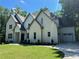 Two-story white brick home with gray accents, landscaping, and a two-car garage at 270 Crosstree Ln, Atlanta, GA 30328