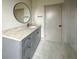 Modern bathroom with gray vanity, quartz countertop, and round mirror at 270 Crosstree Ln, Atlanta, GA 30328