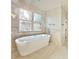 Relaxing bathroom with a large soaking tub and bright window at 270 Crosstree Ln, Atlanta, GA 30328