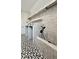 Laundry room with built-in dog shower, white tile, and modern shelving at 270 Crosstree Ln, Atlanta, GA 30328
