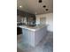 L-shaped basement bar with gray cabinets and a concrete countertop at 270 Crosstree Ln, Atlanta, GA 30328