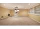 Finished basement room with carpet, lighting, and access to kitchen at 14 Mckelvey Nw Ct, Cartersville, GA 30121