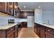 Spacious kitchen with dark wood cabinets and granite counters at 6120 Ripple Way # 46, South Fulton, GA 30349