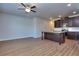 Open concept living room and kitchen with hardwood floors and ceiling fan at 6120 Ripple Way # 46, South Fulton, GA 30349