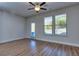 Bright living room with hardwood floors, ceiling fan, and door to patio at 6120 Ripple Way # 46, South Fulton, GA 30349