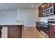Modern kitchen with granite countertops, stainless steel appliances, and dark wood cabinets at 6120 Ripple Way # 46, South Fulton, GA 30349