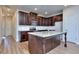 Modern kitchen with granite countertops, stainless steel appliances, and dark wood cabinets at 6120 Ripple Way # 46, South Fulton, GA 30349