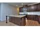 Modern kitchen with granite countertops, stainless steel appliances, and dark wood cabinets at 6120 Ripple Way # 46, South Fulton, GA 30349