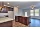 Spacious kitchen with an island, granite countertops, and dark wood cabinets at 6104 Ripple Way # 50, South Fulton, GA 30349