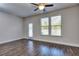 Spacious living room with hardwood floors, ceiling fan, and door to patio at 6104 Ripple Way # 50, South Fulton, GA 30349