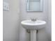 Small bathroom with pedestal sink and framed mirror at 6104 Ripple Way # 50, South Fulton, GA 30349