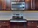 Stainless steel range and microwave above in modern kitchen at 6104 Ripple Way # 50, South Fulton, GA 30349