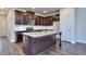 Modern kitchen with granite island, stainless steel appliances, and dark wood cabinets at 6104 Ripple Way # 50, South Fulton, GA 30349