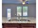 Kitchen island with granite countertop and double sink, overlooking backyard at 6104 Ripple Way # 50, South Fulton, GA 30349